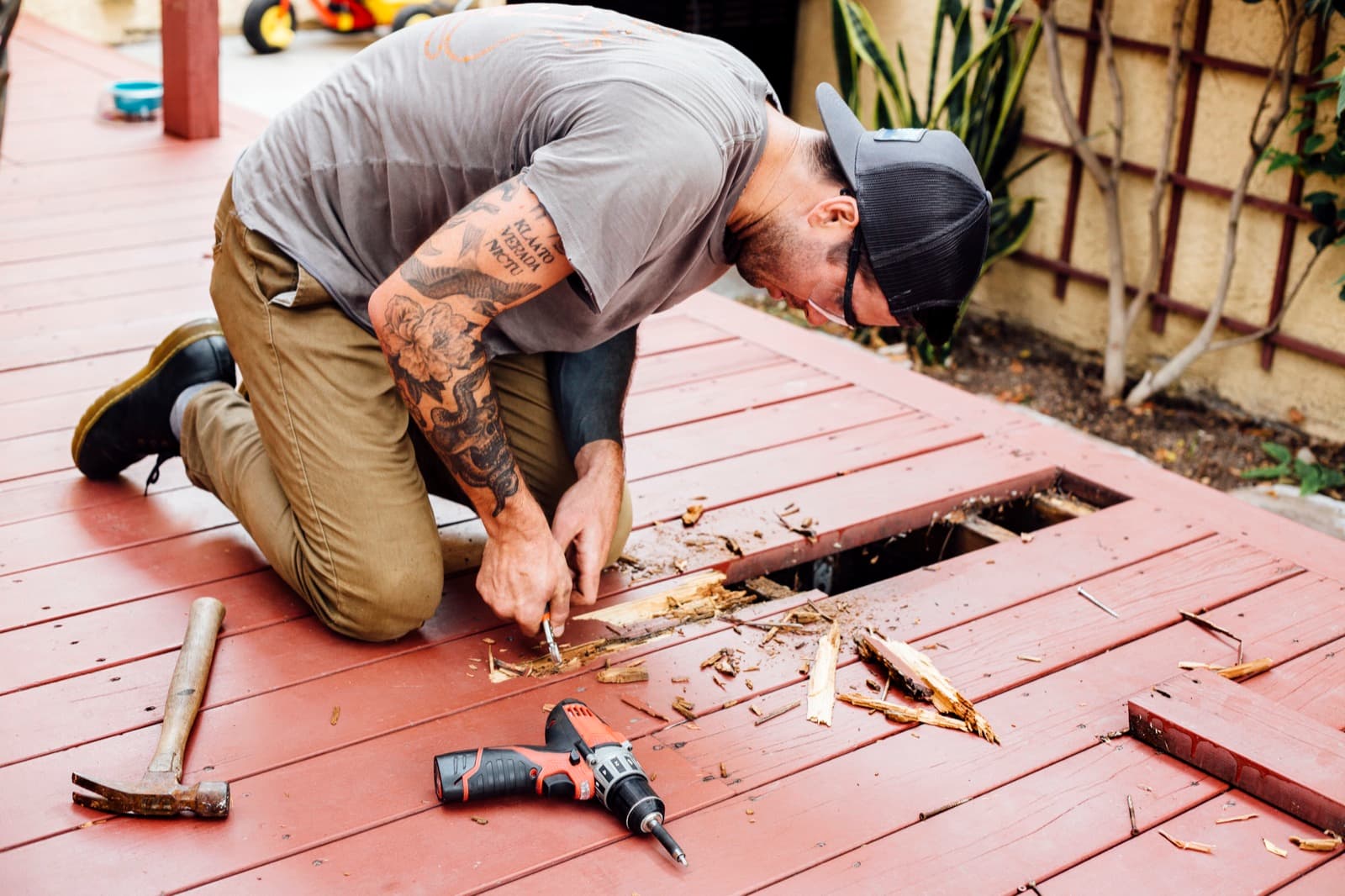 Carpenter installing a composite deck on a residential backyard