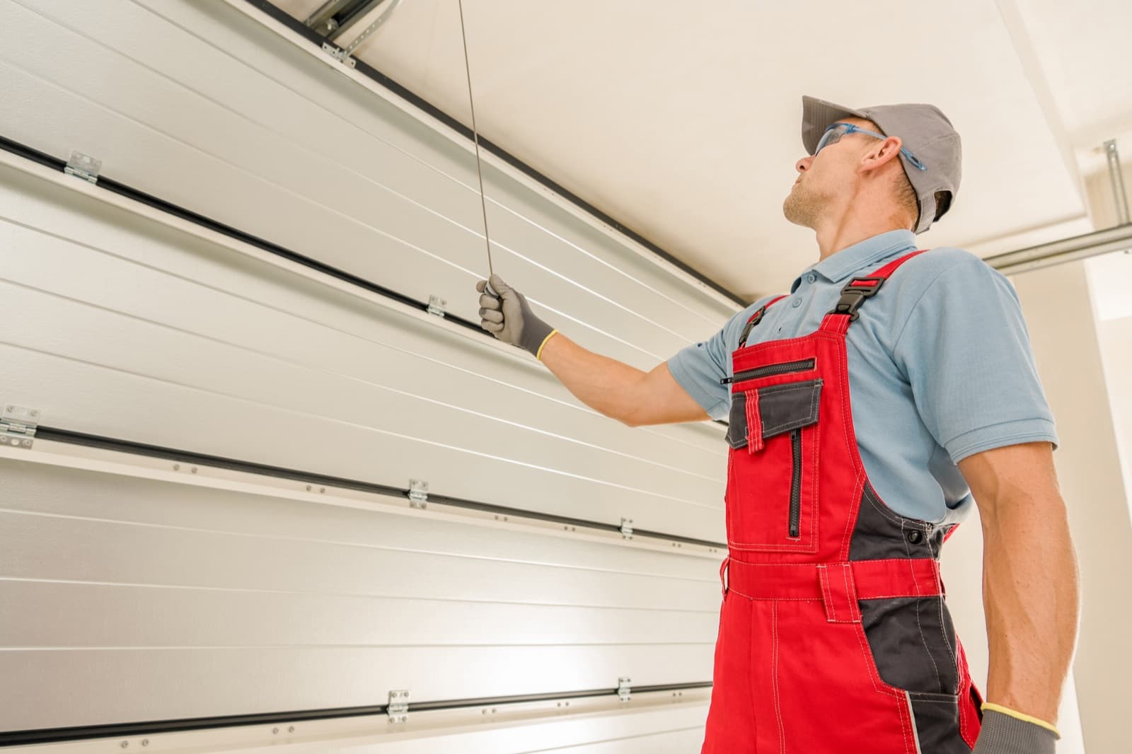Garage door technician installing a residential overhead door