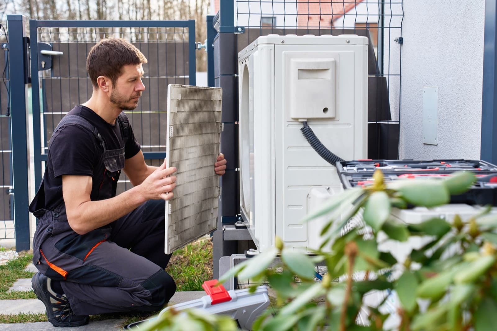 HVAC technician servicing an outdoor condenser unit