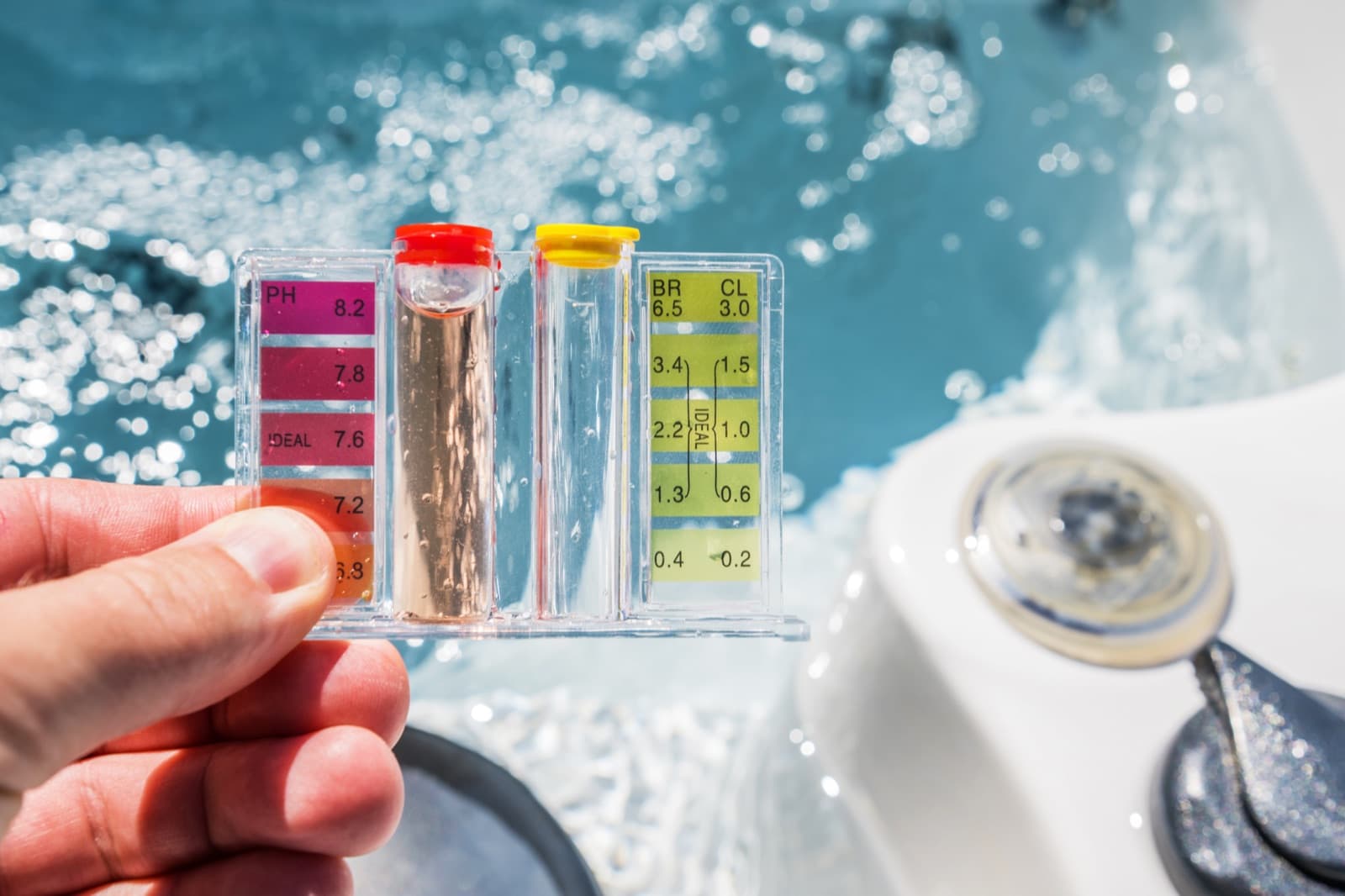 Pool service technician testing water chemistry on a residential pool deck